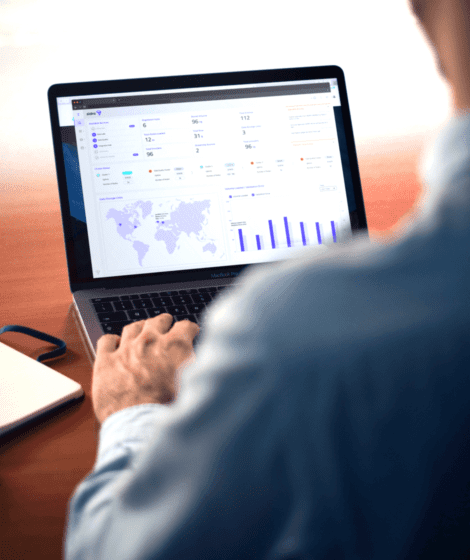 man looking at charts on a computer