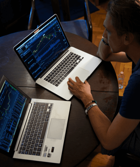man looking at two computer screens